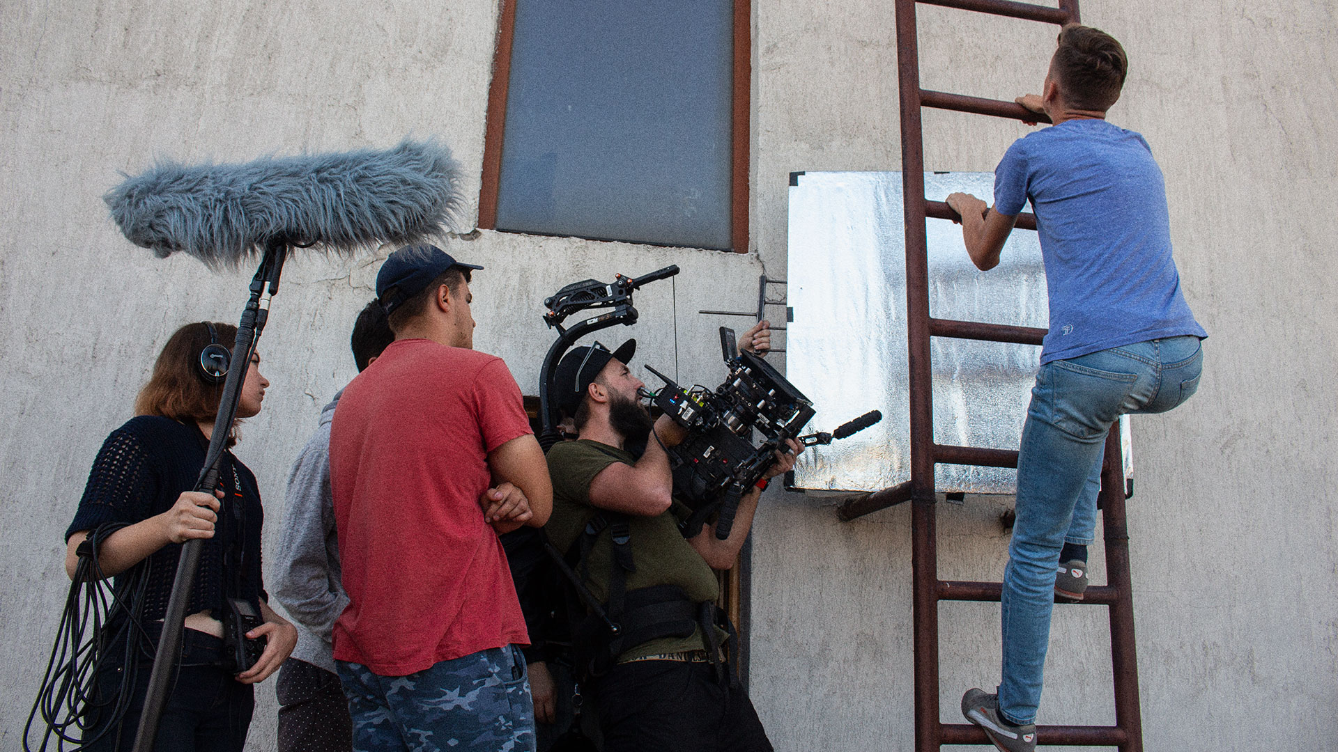 Filming the shot where the main character is climbing up the ladder.